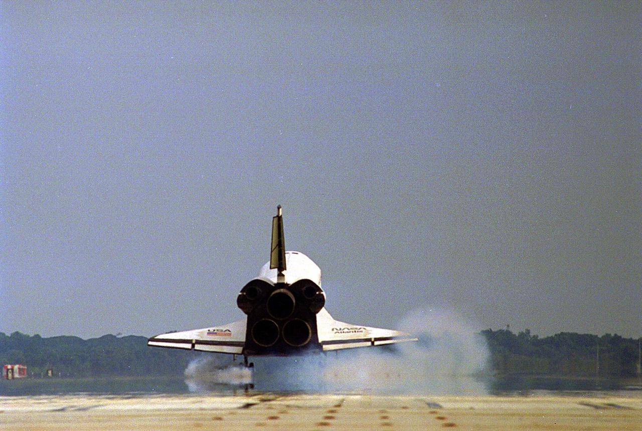 The Space Shuttle orbiter Atlantis touches down on Runway 33 of the KSC Shuttle Landing Facility, bringing to an end the nine-day STS-84 mission. Main gear touchdown was at 9:27:44 EDT on May 24, 1997. The first landing opportunity was waved off because of low cloud cover. It was the 37th landing at KSC since the Shuttle program began in 1981, and the eighth consecutive landing at KSC. STS-84 was the sixth of nine planned dockings of the Space Shuttle with the Russian Space Station Mir. Atlantis was docked with the Mir for five days. STS-84 Mission Specialist C. Michael Foale replaced astronaut and Mir 23 crew member Jerry M. Linenger, who has been on the Russian space station since Jan. 15. Linenger returned to Earth on Atlantis with the rest of the STS-84 crew, Mission Commander Charles J. Precourt, Pilot Eileen Marie Collins, and Mission Specialists Carlos I. Noriega, Edward Tsang Lu, Elena V. Kondakova of the Russian Space Agency and JeanFrancois Clervoy of the European Space Agency. Foale is scheduled to remain on the Mir for approximately four months, until he is replaced by STS-86 crew member Wendy B. Lawrence in September. Besides the docking and crew exchange, STS-84 included the transfer of more than 7,300 pounds of water, logistics and science experiments and hardware to and from the Mir. Scientific experiments conducted during the STS-84 mission, and scheduled for Foale’s stay on the Mir, are in the fields of advanced technology, Earth sciences, fundamental biology, human life sciences, International Space Station risk mitigation, microgravity sciences and space sciences