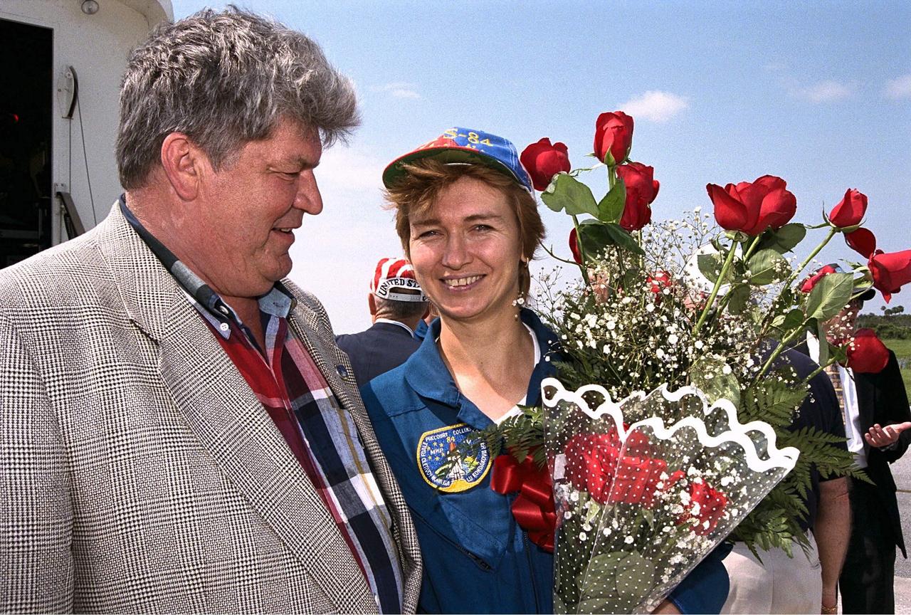 Veteran cosmonaut Valery Ryumin greets his wife, STS-84 Mission Specialist Elena V. Kondakova, with some flowers after the Space Shuttle orbiter Atlantis lands on KSC’s Runway 33. STS-84 was the sixth docking of the Space Shuttle with the Russian Space Station Mir. The nine-day STS-84 mission was Kondakova’s second space flight, but her first on the Space Shuttle. She spent 169 days in space as flight engineer of the 17th main mission on Mir from October 1994 to March 1995. Her husband is now director of the Mir-Shuttle program for Russia
