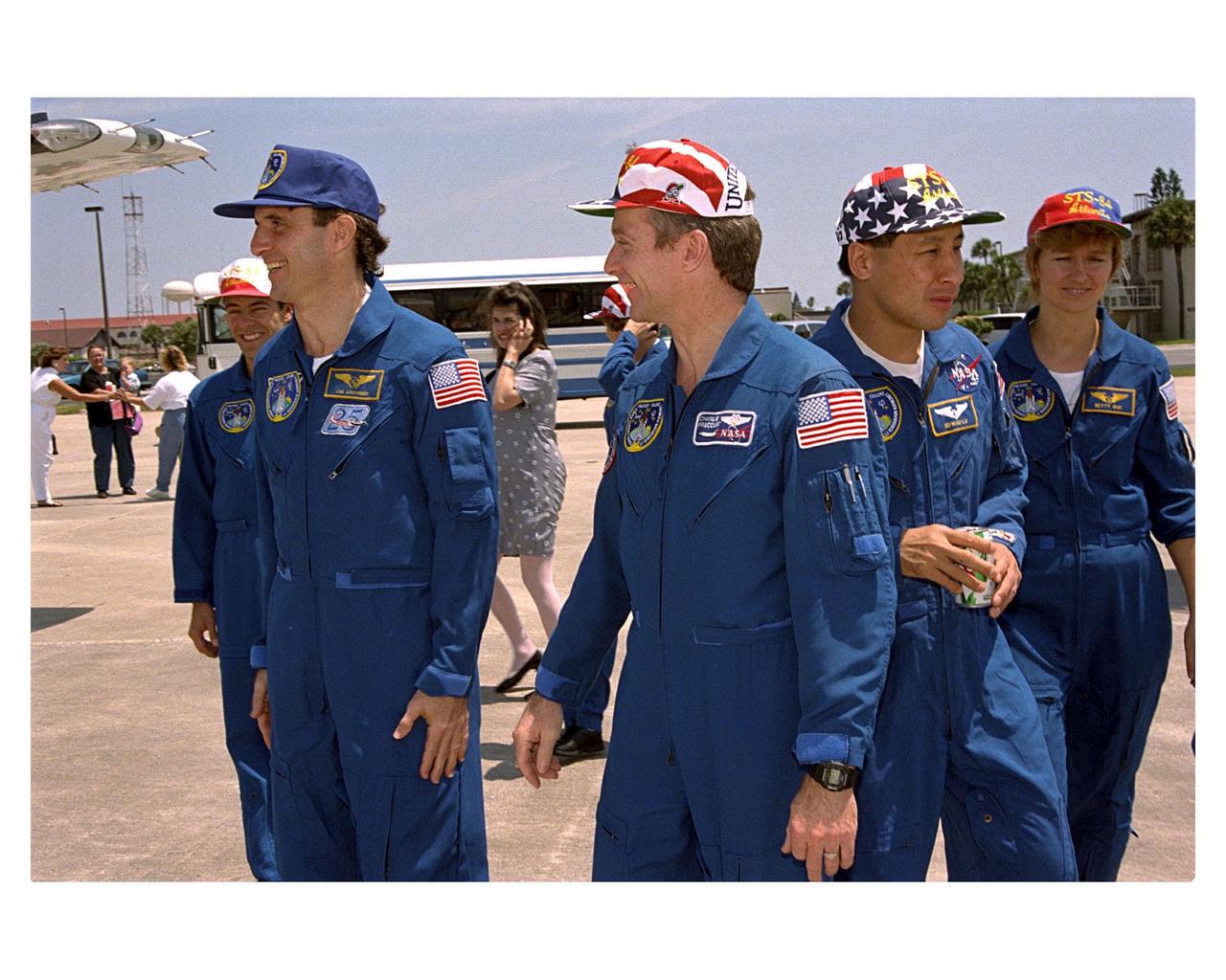 KENNEDY SPACE CENTER, FLA. - Members of the STS-84 crew pause at Patrick Air force Base just prior to their departure for Johnson Space Center in Houston, Texas. They are (from left) Mission Specialist Jean-Francois Clervoy; returning astronaut and Mir 23 crew member Jerry M. Linenger; Mission Commander Charles J. Precourt; Mission Specialist Edward Tsang Lu; and Mission Specialist Elena V. Kondakova. The seven-member crew returned aboard the Space Shuttle Orbiter Atlantis May 24 on KSC's Runway 33 after the completion of a successful nine-day mission. STS-84 was the sixth docking of the Space Shuttle with the Russian Space Station MIr. Atlantis was docked with the Mir for five days. STS-84 Mission Specialist C. Michael Foale replaced Linenger, who had been on the Russian space station since Jan. 15. Besides the docking and crew exchange, STS-84 included the transfer of more than 7,300 pounds of water, logistics and science experiments and hardware to and from the Mir. Scientific experiments conducted during the STS-84 mission, and scheduled for Foale's stay on the Mir, are in the fields of advanced technology, Earth sciences, fundamental biology, human life sciences, International Space Station risk mitigation, microgravity sciences and space sciences.