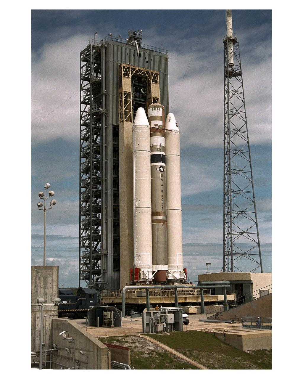 The Titan IVB core vehicle and its twin Solid Rocket Motor Upgrades (SRMUs) which will be used to propel the Cassini spacecraft to its final destination, Saturn, arrive at the pad at Launch Complex 40, Cape Canaveral Air Station. At the pad, the Centaur upper stage will be added and, eventually, the prime payload, the Cassini spacecraft. Cassini will explore the Saturnian system, including the planet’s rings and moon, Titan. Launch of the Cassini mission to Saturn is scheduled for Oct. 6