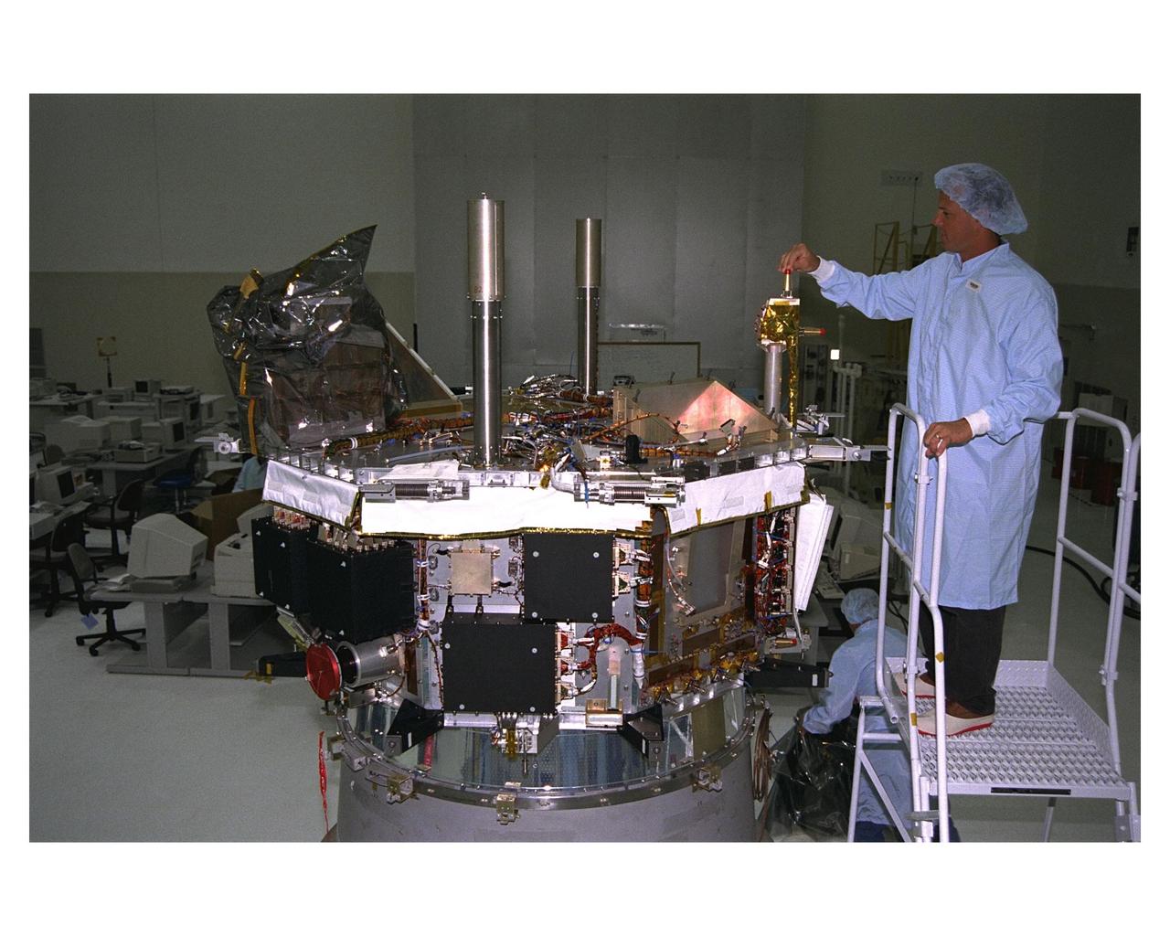 Workers in the Spacecraft Assembly and Encapsulation Facility-2 (SAEF-2) begin prelaunch processing of the Advanced Composition Explorer (ACE) which will investigate the origin and evolution of solar phenomenon, the formation of the solar corona, solar flares and the acceleration of the solar wind. ACE was built for NASA by the Johns Hopkins Applied Physics Laboratory. The spacecraft is scheduled to be launched Aug. 21 aboard a two-stage Delta II 7920-8 rocket from Space Launch Complex 17, Pad A