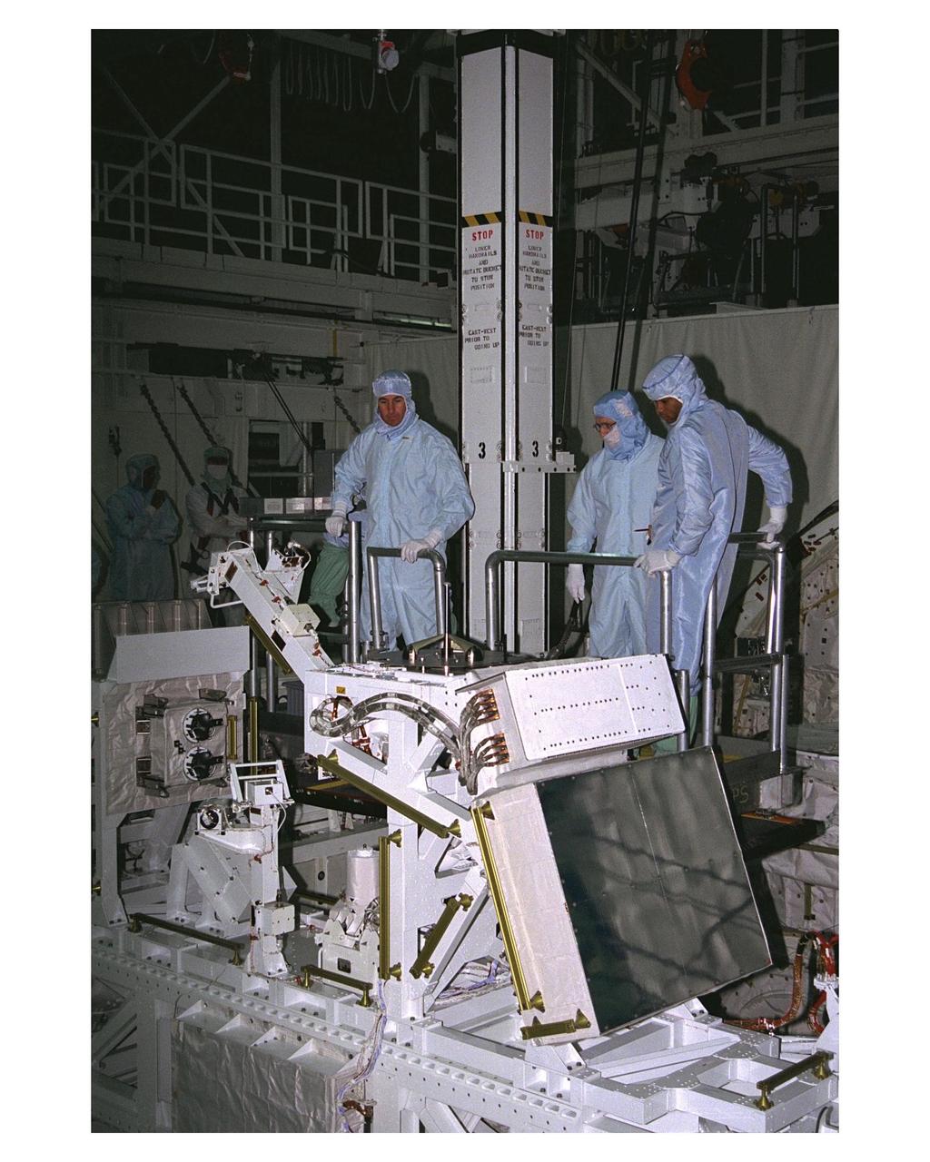 KENNEDY SPACE CENTER, FLA. -- Members of the STS-85 flight crew examine the Manipulator Flight Demonstraton (MFD) payload in the payload bay of the Space Shuttle Orbiter Discovery during Crew Equipment Interface Test (CEIT) activities for that mission.  They are (left) Mission Specialists Stephen K. Robinson and Robert L. Curbeam Jr. (right).  They are accompanied by a United Space Alliance (USA) payload technician.  The MFD is one of several payloads that will fly on the STS-85 mission.  This payload is designed to test the operational capability of the Japanese Experiment Module Remote Manipulator System (JEM RMS) Small Fine Arm (SFA), which can be seen atop its Multi-Purpose Experiment Support Structure (MPES) carrier that will serve as a platform in the payload bay for the robotic arm experiment.  The arm, which will be a part of the JEM element of the Interntional Space Station, will be operated from the orbiter's aft flight deck during the 11-day mission.  Other payloads that will be aboard Discovery on this space flight include the Cryogenic Infrared Spectrometers and Telescopes for the Atmosphere-Shuttle Pallet Satellite-2 (CRISTA-SPAS-2) Technology Applications and Science-1 (TAS-1) and International Extreme Ultraviolet Hitchhhiker (IEH-2) experiments.