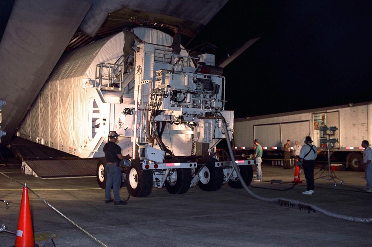 Node 1, the first element of the International Space Station to be manufactured in the United States and the first to be launched on the Space Shuttle, is unloaded in its container from an Air Force C-5 jet cargo transport at KSC’s Shuttle Landing Facility runway on June 23 after its arrival from NASA’s Marshall Space Flight Center (MSFC). The module was then transported to the Space Station Processing Facility. The Node 1 module is currently scheduled to lift off aboard the Space Shuttle Endeavour in July 1998 along with Pressurized Mating Adapters (PMAs) 1 and 2. The 18-foot-in-diameter, 22-foot-long aluminum module was manufactured by the Boeing Co. at MSFC. Once in space, the Node 1 will function as a connecting passageway to the living and working areas of the International Space Station. It has six hatches that will serve as docking ports to the U.S. laboratory module, U.S. habitation module, an airlock and other Space Station elements
