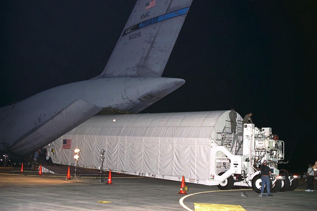 Node 1, the first element of the International Space Station to be manufactured in the United States and the first to be launched on the Space Shuttle, is unloaded in its container from an Air Force C-5 jet cargo transport at KSC’s Shuttle Landing Facility runway on June 23 after its arrival from NASA’s Marshall Space Flight Center (MSFC). The module was then transported to the Space Station Processing Facility. The Node 1 module is currently scheduled to lift off aboard the Space Shuttle Endeavour in July 1998 along with Pressurized Mating Adapters (PMAs) 1 and 2. The 18-foot in diameter, 22-foot-long aluminum module was manufactured by the Boeing Co. at MSFC. Once in space, the Node 1 will function as a connecting passageway to the living and working areas of the International Space Station. It has six hatches that will serve as docking ports to the U.S. laboratory module, U.S. habitation module, an airlock and other Space Station elements