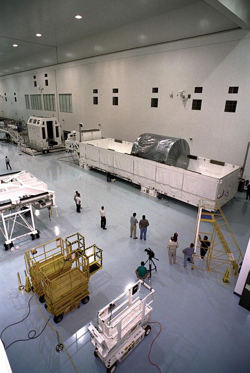 The Node 1, the first element of the International Space Station to be manufactured in the United States and the first to be launched on the Space Shuttle, rests in its container in the Space Station Processing Facility high bay after its arrival at KSC from NASA’s Marshall Space Flight Center (MSFC). The Node 1 module is currently scheduled to lift off aboard the Space Shuttle Endeavour in July 1998 along with Pressurized Mating Adapters (PMAs) 1 and 2. The 18-foot-in-diameter, 22- foot-long aluminum module was manufactured by the Boeing Co. at MSFC. Once in space, the Node 1 will function as a connecting passageway to the living and working areas of the International Space Station. It has six hatches that will serve as docking ports to the U.S. laboratory module, U.S. habitation module, an airlock and other space station elements