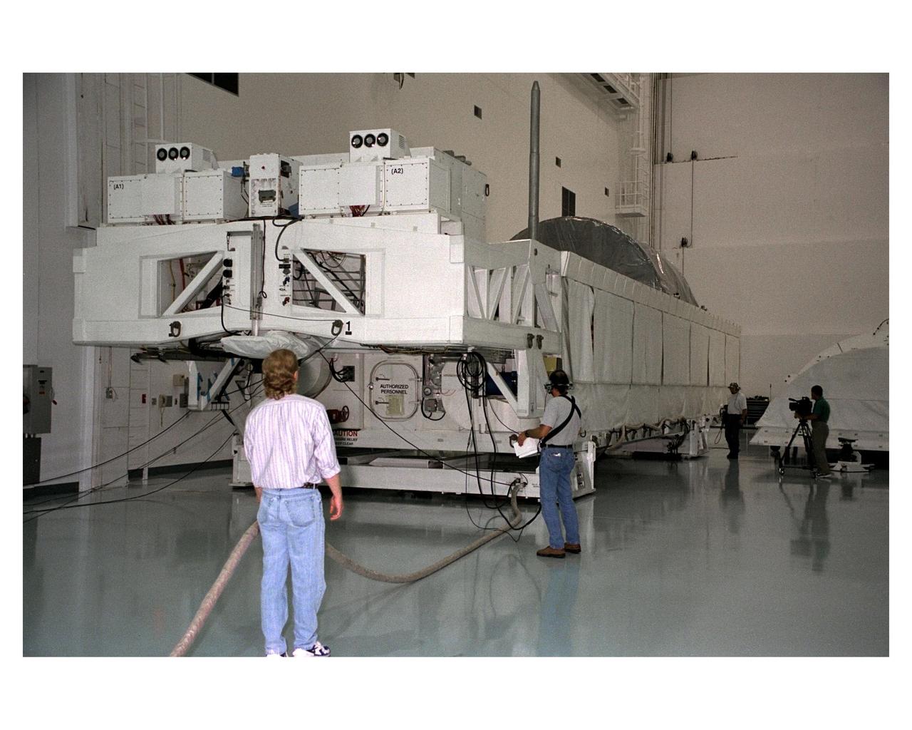 The Node 1, the first element of the International Space Station to be manufactured in the United States and the first to be launched on the Space Shuttle, rests in its container in the Space Station Processing Facility high bay after its arrival at KSC from NASA’s Marshall Space Flight Center (MSFC). The Node 1 module is currently scheduled to lift off aboard the Space Shuttle Endeavour in July 1998 along with Pressurized Mating Adapters (PMAs) 1 and 2. The 18-foot in diameter, 22- foot-long aluminum module was manufactured by the Boeing Co. at MSFC. Once in space, the Node 1 will function as a connecting passageway to the living and working areas of the International Space Station. It has six hatches that will serve as docking ports to the U.S. laboratory module, U.S. habitation module, an airlock and other space station elements