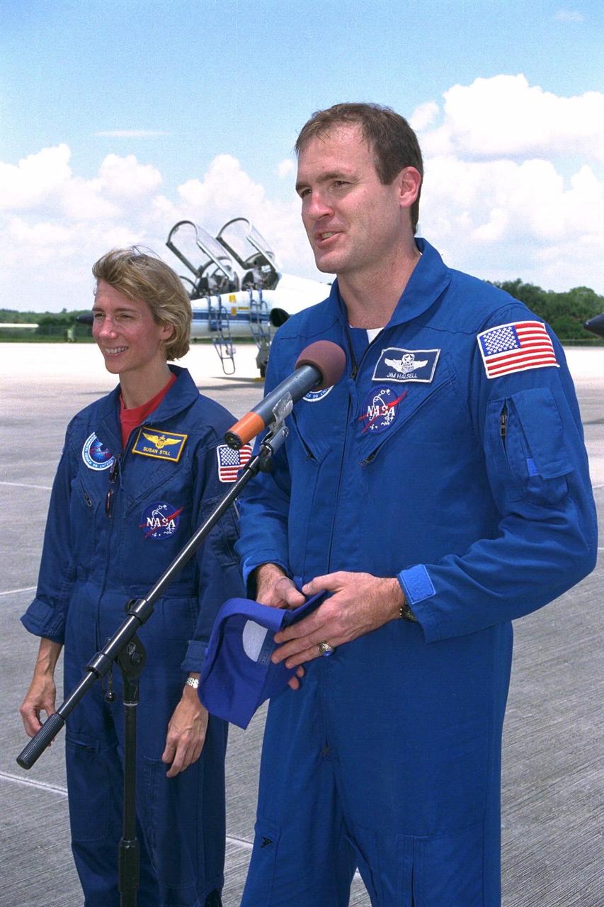 STS-94 Pilot Susan Leigh Still watches as Commander James D. Halsell, Jr., speaks to the media after the crew arrived at the Shuttle Landing Facility  at Kennedy Space Center in preparation for the reflight of the Microgravity Science Laboratory-1 mission. Launch is scheduled for July 1, 1997, at 2:37 p.m. EDT.  The laboratory was scheduled to fly again with the full complement of STS-83 experiments after  that mission was cut short due to a faulty fuel cell. During the scheduled 16-day STS-94 mission, the experiments will be used to test some  of the hardware, facilities and procedures that are planned for use on the International  Space Station while the flight crew conducts combustion, protein crystal growth and  materials processing experiments