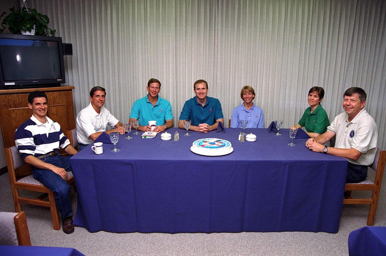 The STS-94 flight crew enjoys the traditional  preliftoff breakfast in the crew quarters of the Operations and Checkout Building. They  are  (from left): Payload Specialist Gregory T. Linteris; Mission Specialist Donald A.  Thomas; Mission Specialist Michael L. Gernhardt; Mission Commander James D.  Halsell, Jr.; Pilot Susan  L. Still; Payload Commander Janice Voss; and Payload  Specialist Roger K. Crouch. After a weather briefing, the flight crew will be fitted with  their launch/entry suits and depart for Launch Pad 39A. Once there, they will take their  positions  in the crew cabin of the Space Shuttle Columbia to await a liftoff during a  window that will open at 1:50 p.m. EDT, July 1. The launch window was opened 47  minutes early to improve the opportunity to lift off before Florida summer rain showers reached the space center