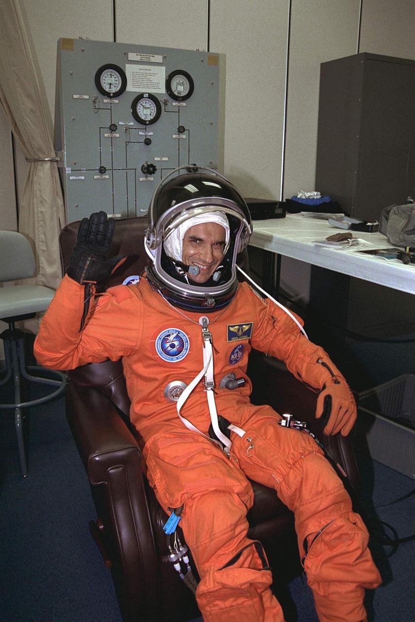 STS-94 Payload Specialist Gregory T. Linteris  waves as he completes the donning of his launch/entry suit in the Operations and  Checkout (O&C) Building. He holds a doctorate in mechanical and aerospace  engineering. Linteris has worked at the National Institute of Standards and Technology  and is the Principal Investigator on a NASA microgravity combustion experiment. As a  member of the  Red team, Linteris will concentrate on  three  combustion experiments.  Two of these experiments are housed in the  Combustion Module. He will also be  backing up crew members on the other Microgravity Science Laboratory-1 (MSL-1)  investigations. He and six fellow crew members will shortly depart the O&C and head for  Launch Pad 39A, where the  Space Shuttle Columbia will lift off  during a launch  window that opens at 1:50 p.m. EDT, July 1. The launch window was opened 47 minutes  early to improve the opportunity to lift off before Florida summer rain showers reached  the space center
