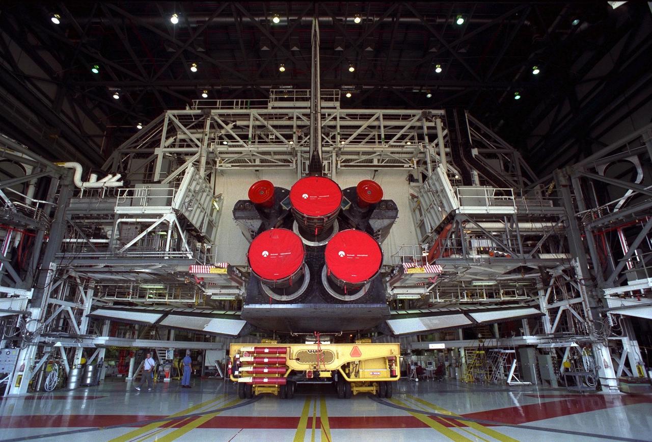 The Space Shuttle Orbiter Discovery in Orbiter Processing Facility 2 begins its rollover on top of the orbiter transporter to the Vehicle Assembly Building for mating with its external tank and solid rocket boosters in preparation for the STS-85 mission. Several payloads will be aboard Discovery during the 11-day mission, including the Manipulator Flight Demonstration (MFD) and the Cryogenic Infrared Spectrometers and Telescopes for the Atmosphere-Shuttle Pallet Satellite-2 (CRISTA-SPAS-2), as well as the Technology Applications and Science-1 (TAS-1) and International Extreme Ultraviolet Hitchhiker (IEH-2) experiments