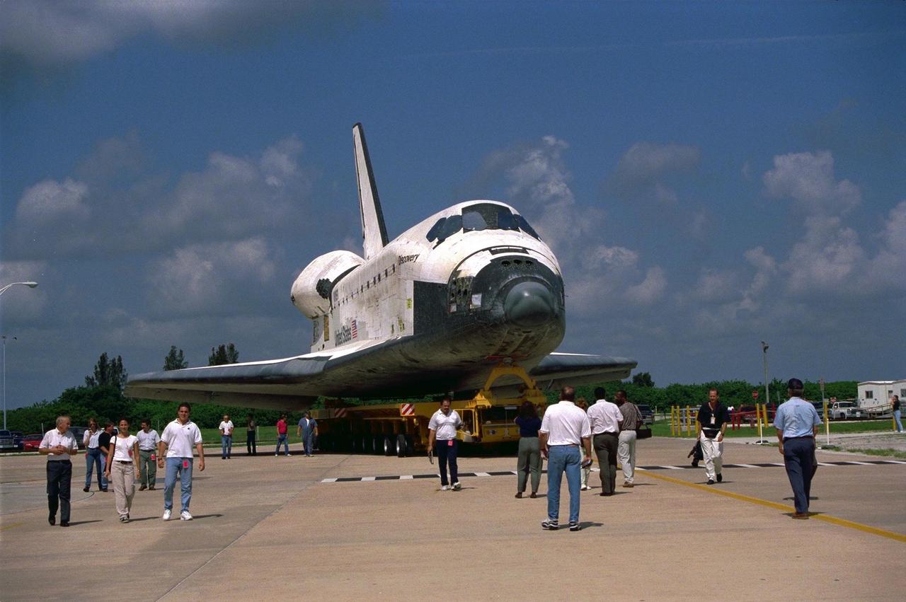 The Space Shuttle Orbiter Discovery rolls over from Orbiter Processing Facility 2 on top of the orbiter transporter to the Vehicle Assembly Building for mating with its external tank and solid rocket boosters in preparation for the STS-85 mission. Several payloads will be aboard Discovery during the 11-day mission, including the Manipulator Flight Demonstration (MFD) and the Cryogenic Infrared Spectrometers and Telescopes for the Atmosphere-Shuttle Pallet Satellite-2 (CRISTA-SPAS-2), as well as the Technology Applications and Science-1 (TAS-1) and International Extreme Ultraviolet Hitchhiker (IEH-2) experiments
