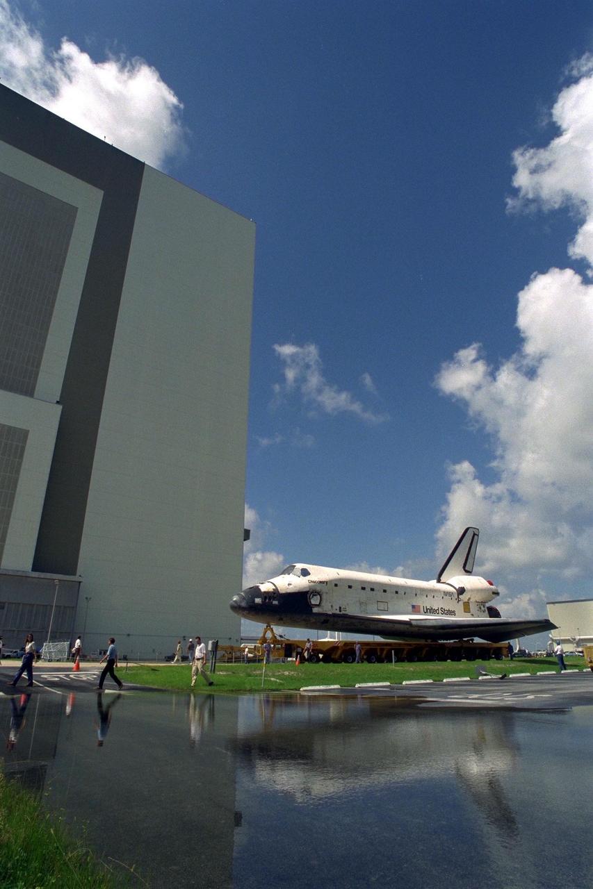 The Space Shuttle Orbiter Discovery rolls over from Orbiter Processing Facility 2 on top of the orbiter transporter to the Vehicle Assembly Building for mating with its external tank and solid rocket boosters in preparation for the STS-85 mission. Several payloads will be aboard Discovery during the 11-day mission, including the Manipulator Flight Demonstration (MFD) and the Cryogenic Infrared Spectrometers and Telescopes for the Atmosphere-Shuttle Pallet Satellite-2 (CRISTA-SPAS-2), as well as the Technology Applications and Science-1 (TAS-1) and International Extreme Ultraviolet Hitchhiker (IEH-2) experiments