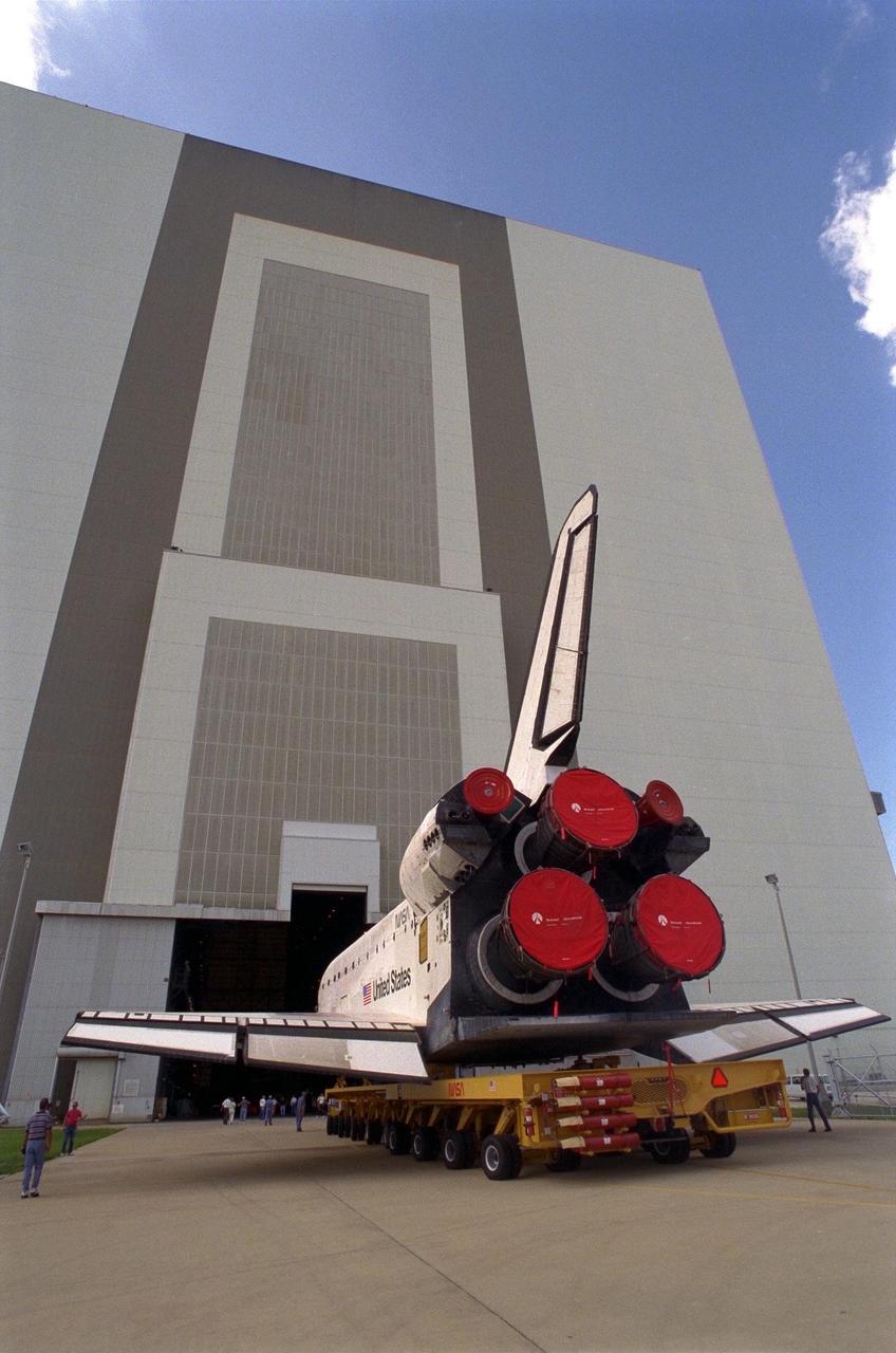 The Space Shuttle Orbiter Discovery rolls over from Orbiter Processing Facility 2 on top of the orbiter transporter to the Vehicle Assembly Building for mating with its external tank and solid rocket boosters in preparation for the STS-85 mission. Several payloads will be aboard Discovery during the 11-day mission, including the Manipulator Flight Demonstration (MFD) and the Cryogenic Infrared Spectrometers and Telescopes for the Atmosphere-Shuttle Pallet Satellite-2 (CRISTA-SPAS-2), as well as the Technology Applications and Science-1 (TAS-1) and International Extreme Ultraviolet Hitchhiker (IEH-2) experiments