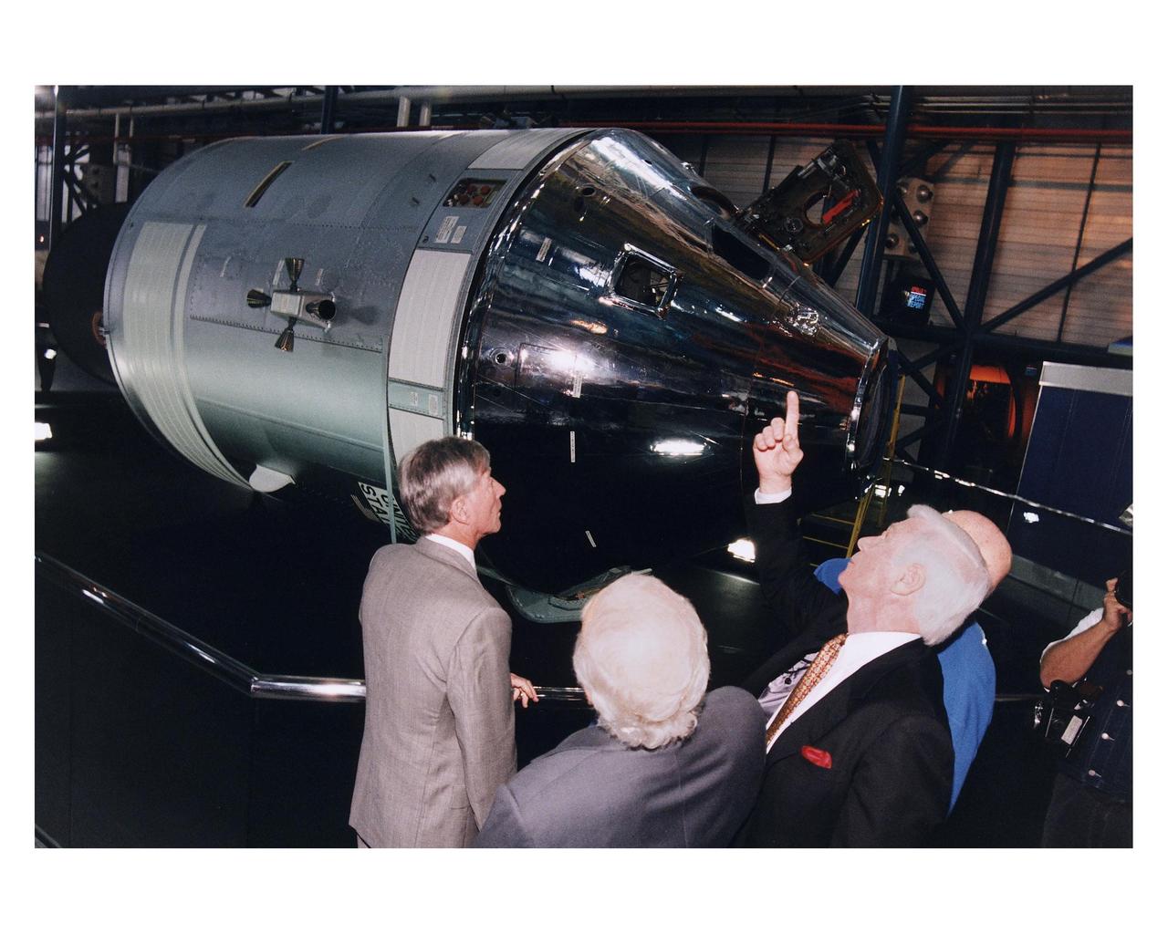 KENNEDY SPACE CENTER, FLA. -- Some of the former Apollo program astronauts admire an Apollo Command and Service Module during a tour the new Apollo/Saturn V Center (ASVC) at KSC prior to the gala grand opening ceremony for the facility that was held Jan. 8, 1997. The astronauts were invited to participate in the event, which also featured NASA Administrator Dan Goldin and KSC Director Jay Honeycutt. The astronauts are (from left): Apollo 10 Command Module Pilot and Apollo 16 Commander John W. Young;. Apollo 11 Lunar Module Pilot Edwin E. "Buzz" Aldrin, Jr.; Apollo 17 Commander Eugene A. Cernan; and Apollo 10 Commander Thomas P. Stafford. The ASVC also features several other Apollo program spacecraft components, multimedia presentations and a simulated Apollo/Saturn V liftoff. The facility will be a part of the KSC bus tour that embarks from the KSC Visitor Center