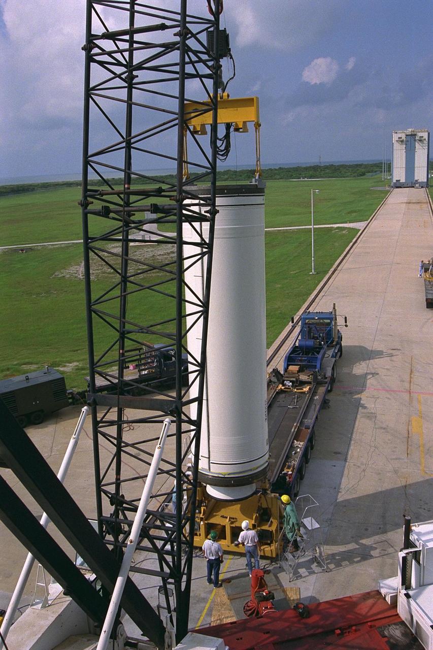 Workers hoist the first stage of a Lockheed Martin Launch Vehicle-2 (LMLV-2) for placement at Launch Complex 46 at Cape Canaveral Air Station (CCAS), Fla. The Lunar Prospector spacecraft is scheduled to launch aboard the LMLV-2 from CCAS in October for an 18-month mission that will orbit the Earth’s Moon to collect data from the lunar surface. Information gathered during the mission will allow construction of a detailed map of the surface composition of the Moon and will improve our understanding of its origin, evolution, current state, and resources