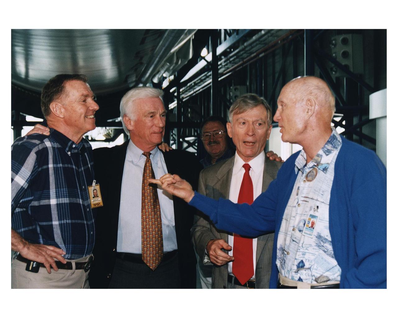 KENNEDY SPACE CENTER, FLA. -- Some of the former Apollo program astronauts recall the past as they tour the new Apollo/Saturn V Center (ASVC) at KSC prior to the gala grand opening ceremony for the facility that was held Jan. 8, 1997. The astronauts were invited to participate in the event, which also featured NASA Administrator Dan Goldin and KSC Director Jay Honeycutt. Standing underneath the KSC Apollo/Saturn V inside the building are (from left): Apollo 14 Back-up Lunar Module Pilot Joe H. Engle; Apollo 10 Lunar Module Pilot and Apollo 17 Commander Eugene A. Cernan; Apollo 10 Command Module Pilot and Apollo 16 Commander John W. Young; and Apollo 10 Commander Thomas P. Stafford. The ASVC also features several other Apollo program spacecraft components, multimedia presentations and a simulated Apollo/Saturn V liftoff. The facility will be a part of the KSC bus tour that embarks from the KSC Visitor Center