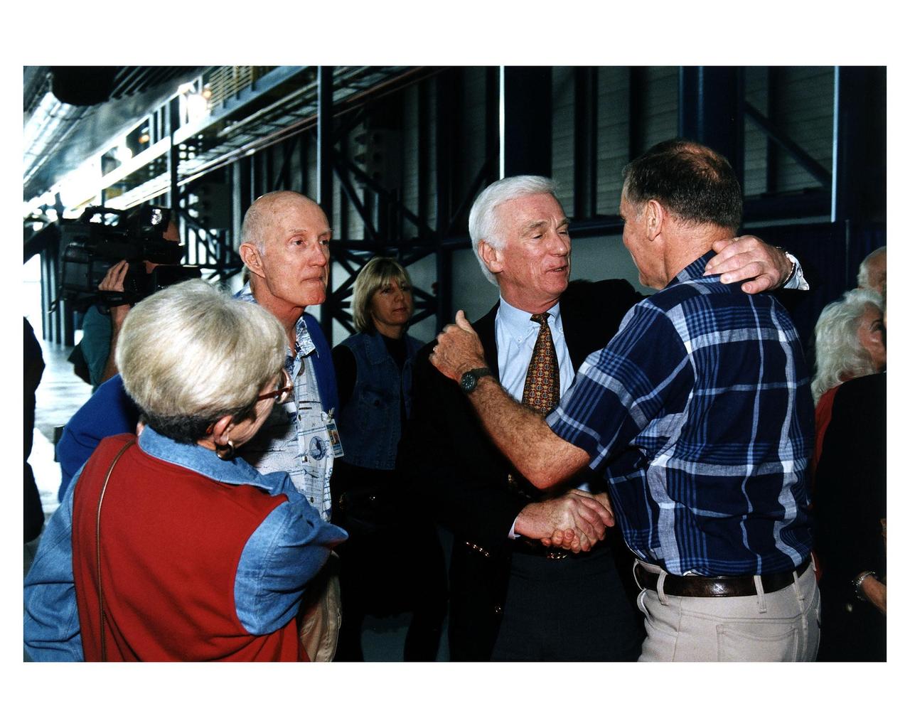 KENNEDY SPACE CENTER, FLA. -- Some of the former Apollo program astronauts tour the new Apollo/Saturn V Center (ASVC) at KSC prior to the gala grand opening ceremony for the facility that was held Jan. 8, 1997. The astronauts were invited to participate in the event, which also featured NASA Administrator Dan Goldin and KSC Director Jay Honeycutt. Greeting friends in the ASVC (left) is Apollo 10 Commander Thomas P. Stafford. Apollo 10 Lunar Module Pilot and Apollo 17 Commander Eugene A. Cernan shakes hands with Apollo 14 Back-up Lunar Module Pilot Joe H. Engle. The ASVC also features several other Apollo program spacecraft components, multimedia presentations and a simulated Apollo/ Saturn V liftoff. The facility will be a part of the KSC bus tour that embarks from the KSC Visitor Center