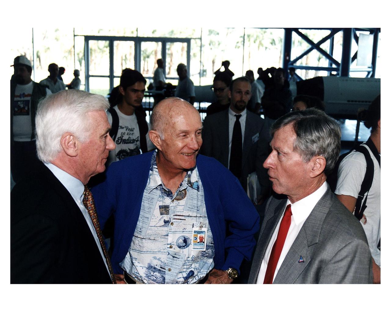 KENNEDY SPACE CENTER, FLA. -- Some of the former Apollo program astronauts tour the new Apollo/Saturn V Center (ASVC) at KSC prior to the gala grand opening ceremony for the facility that was held Jan. 8, 1997. The astronauts were invited to participate in the event, which also featured NASA Administrator Dan Goldin and KSC Director Jay Honeycutt. Discussing old times are (from left) Apollo 10 Lunar Module Pilot and Apollo 17 Commander Eugene A. Cernan; Apollo 10 Commander Thomas P. Stafford and Apollo 16 Commander John W. Young. The ASVC also features several other Apollo program spacecraft components, multimedia presentations and a simulated Apollo/ Saturn V liftoff. The facility will be a part of the KSC bus tour that embarks from the KSC Visitor Center