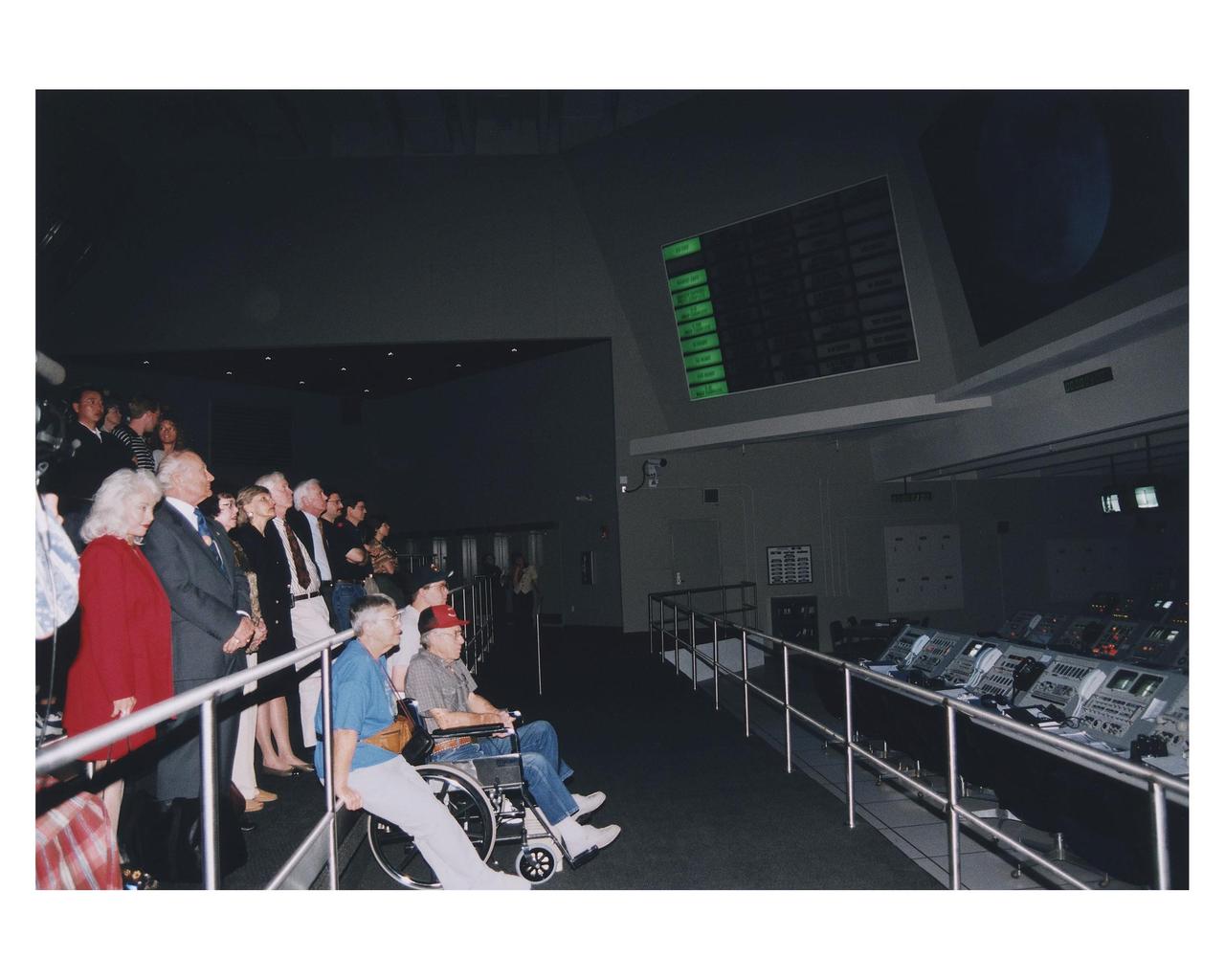 KENNEDY SPACE CENTER, FLA. -- Several Apollo program astronauts, along with their family members and friends, watch a simulation of an Apollo/Saturn V launch in a replica of a Launch Control Center firing room in the new Apollo/Saturn V Center (ASVC) at KSC prior to the gala grand opening ceremony for the facility that was held Jan. 8, 1997. The astronauts were invited to participate in the event, which also featured NASA Administrator Dan Goldin and KSC Director Jay Honeycutt. The ASVC also features several other Apollo program spacecraft component displays and multimedia presentations. The facility will be a part of the KSC bus tour that embarks from the KSC Visitor Center