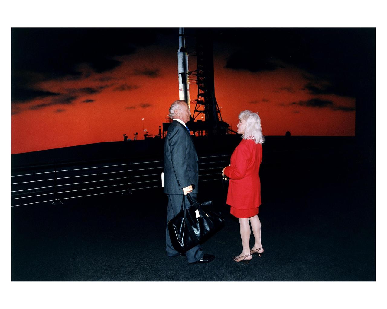 KENNEDY SPACE CENTER, FLA. -- Apollo 11 Lunar Module Pilot Edwin E. "Buzz" Aldrin, Jr. and his wife, Lois, stand before a painting of an Apollo/Saturn V launch vehicle at the pad in the new Apollo/Saturn V Center (ASVC) at KSC prior to the gala grand opening ceremony for the facility that was held Jan. 8, 1997. The astronauts were invited to participate in the event, which also featured NASA Administrator Dan Goldin and KSC Director Jay Honeycutt. The ASVC also features several other Apollo program spacecraft component displays and multimedia presentations. The facility will be a part of the KSC bus tour that embarks from the KSC Visitor Center