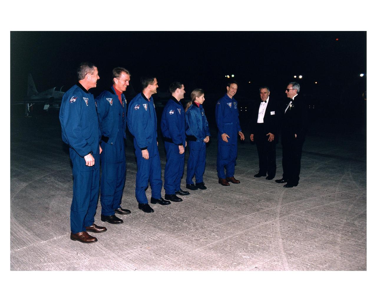 The STS-81 flight crew is welcomed to KSC by NASA Administrator Daniel Goldin (far right) and Johnson Space Center Director George Abbey (second from right) as they arrive at the space center for the final countdown preparations for the fifth Shuttle-Mir docking mission. They are (from left): Mission Commander Michael A. Baker; Pilot Brent W. Jett, Jr.; and Mission Specialists Peter J. K. "Jeff" Wisoff; John M. Grunsfeld, Marsha S. Ivins, and J.M. "Jerry" Linenger. The 10-day mission will feature the transfer of Linenger to Mir to replace astronaut John Blaha, who has been on the orbital laboratory since Sept. 19, 1996 after arrival there during the STS-79 mission. During STS-81, Shuttle and Mir crews will conduct risk mitigation, human life science, microgravity and materials processing experiments that will provide data for the design, development and operation of the International Space Station. The primary payload is the SPACEHAB-DM double module which will provide space for more than 2,000 pounds of hardware, food and water that will be transferred into the Russian space station during five days of docking operations. The SPACEHAB will also be used to return experiment samples from the Mir to Earth for analysis and for microgravity experiments during the mission