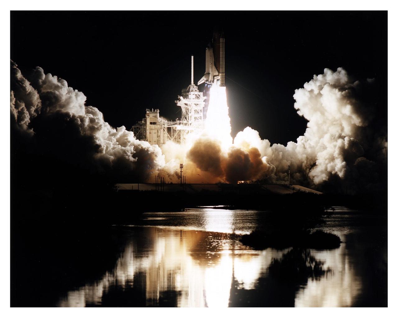 Like a rising sun lighting up the night, the Space Shuttle Atlantis soars from Launch Pad 39B at 4:27:23 a.m. EST Jan. 12 on its way to dock with the Mir space station for the fifth time. The 10-day mission will feature the transfer of Mission Specialist Jerry Linenger to Mir to replace astronaut John Blaha, who has been on the orbital laboratory since Sept. 19, 1996. The other STS-81 crew members include Mission Commander Michael A. Baker; Pilot Brent W. Jett, Jr.; and Mission Specialists John M. Grunsfeld, Peter J. K. "Jeff" Wisoff and Marsha S. Ivins. During the five-day docking operations, the Shuttle and Mir crews will conduct risk mitigation, human life science, microgravity and materials processing experiments that will provide data for the design, development and operation of the International Space Station. The primary payload is the SPACEHAB-DM double module that will provide space for more than 2,000 pounds of hardware, food and water that will be transferred into the Russian space station.The SPACEHAB will also be used to return experiment samples from the Mir to Earth for analysis and for microgravity experiments during the mission