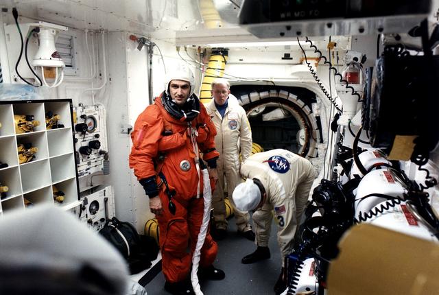 NASA image: KENNEDY SPACE CENTER, FLA. -  STS-81 Mission Specialist Jeff Wisoff prepares to enter the Space Shuttle Atlantis at Launch Pad 39B with help from White Room closeout crew members Danny Wyatt (center) and Al Rochford.