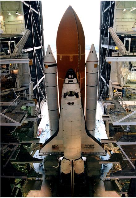 NASA image: KENNEDY SPACE CENTER, FLA. -  After leaving the Vehicle Assembly Building, the Space Shuttle Discovery makes its slow - up to 1 mile per hour - trek along the crawlerway to Launch Pad 39A in preparation for the STS-82 mission.  The Shuttle is assembled on a Mobile Launcher Platform, seen in this view taken from above, and the entire assemblage is carried out to the launch pad on the crawler transporter, which is underneath the MLP.  A seven-member crew will perform the second servicing of the orbiting Hubble Space Telescope (HST) during the 10-day STS-82 mission, which is targeted for a Feb. 11 liftoff.