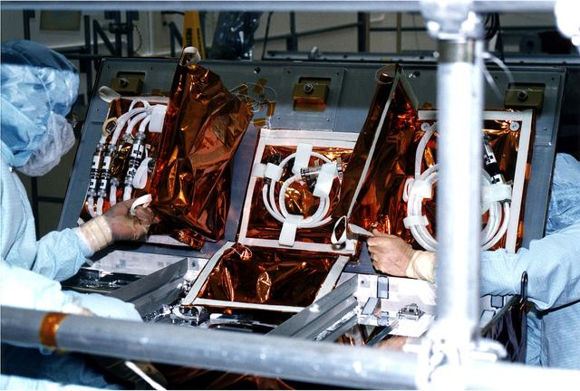 NASA image: KENNEDY SPACE CENTER, FLA. -  Workers in KSC's Vertical Processing Facility stow cable and adapters into a protective enclosure for the second Hubble Space Telescope servicing mission, STS-82.  Liftoff aboard Discovery is targeted Feb. 11 with a crew of seven.