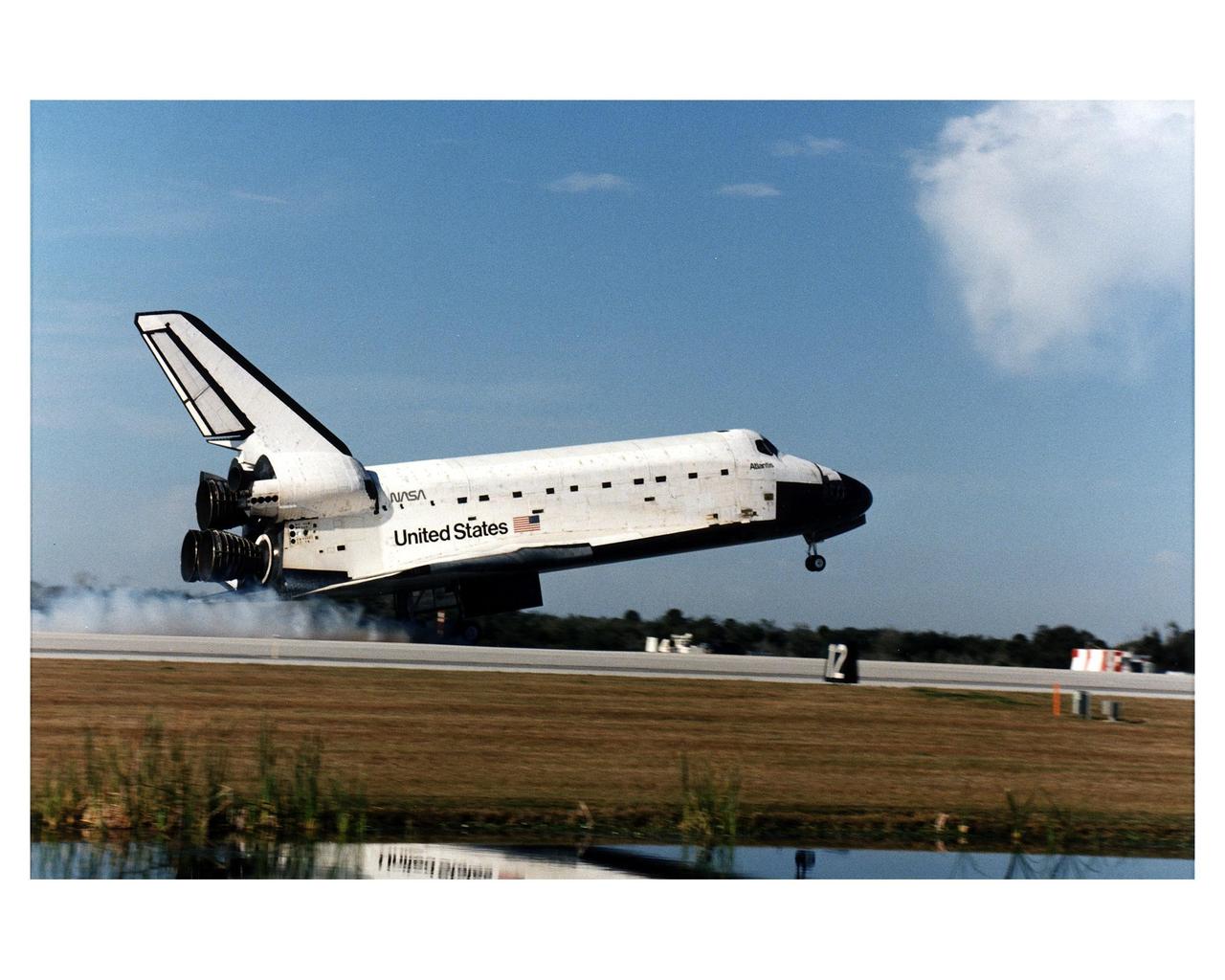 KENNEDY SPACE CENTER, FLA. -- The Space Shuttle orbiter Atlantis touches down on Runway 33 at 9:22:44 a.m. EST Jan. 22 to conclude the fifth Shuttle-Mir docking mission and return NASA astronaut John Blaha to Earth after four months in space. Blaha was replaced by STS-81 Mission Specialist Jerry Linenger during the five days of docked operations. At main gear touchdown, the STS-81 mission duration was 10 days, 4 hours, 55 minutes. This was the 34th KSC landing in Shuttle history. Mission Commander Michael A. Baker flew Atlantis to a perfect landing, with help from Pilot Brent W. Jett, Jr. Other returning STS-81 crew members are Mission Specialists John M. Grunsfeld, Peter J. K. "Jeff" Wisoff and Marsha S. Ivins. Atlantis also brought back experiment samples from the Russian space station for analysis on Earth, along with Russian logistics equipment