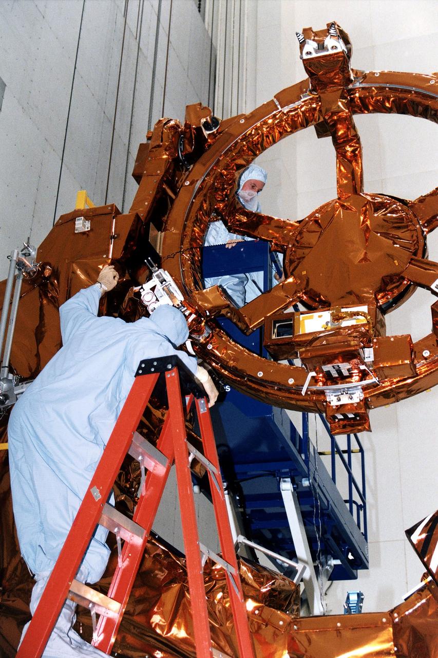 KENNEDY SPACE CENTER, FLA. -  STS-82 Mission Specialist Gregory J. Harbaugh, at top, inspects part of the Flight Support System during the Crew Equipment Integration Test (CEIT) at KSC's Vertical Processing Facility.  Harbaugh and the other six STS-82 crew members will conduct the second Hubble Space Telescope (HST) servicing mission aboard the Space Shuttle Discovery.  Harbaugh will be one of four spacewalkers.  Liftoff aboard Discovery is scheduled Feb. 11.