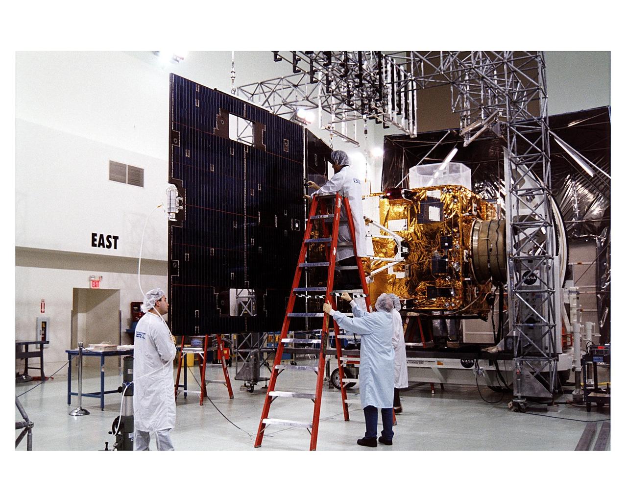 Space Systems/LORAL employees inspect solar panels for the GOES-K weather satellite in the Astrotech facility at Titusville, Fla., as they begin final testing of the imaging system, communications and power systems of the spacecraft. The GOES-K is the third spacecraft to be launched in the new advanced series of geostationary weather satellites for the National Oceanic and Atmospheric Administration (NOAA). The GOES-K is built for NASA and NOAA by Space Systems/LORAL of Palo Alto, Calif. The launch of the satellite from Launch Pad 36B at Cape Canaveral Air Station on an Atlas 1 rocket (AC-79) is currently planned for Apr. 24 at the opening of a launch window which extends from 1:56 to 3:19 a.m. EDT