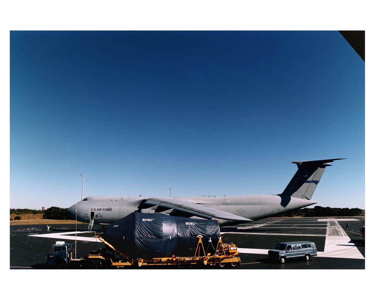 The Centaur upper stage of the Titan IV expendable launch vehicle that will propel the Cassini spacecraft to Saturn and its moon Titan is transported from the Skid Strip at Cape Canaveral Air Station (CCAS) after its arrival via a jet cargo aircraft. The Titan IV is currently scheduled to lift off from Launch Pad 40 at CCAS on October 6. Once deployed from the Centaur upper stage, Cassini will conduct gravity-assist flybys of the planets Venus and Jupiter, then arrive at Saturn in July 2004. Once there, it will perform an orbital survey of Saturn and send the European Space Agency's Huygens Probe into the dense and seemingly Earthlike atmosphere of Titan. The Cassini project is managed by NASA's Jet Propulsion Laboratory (JPL), Pasadena, California
