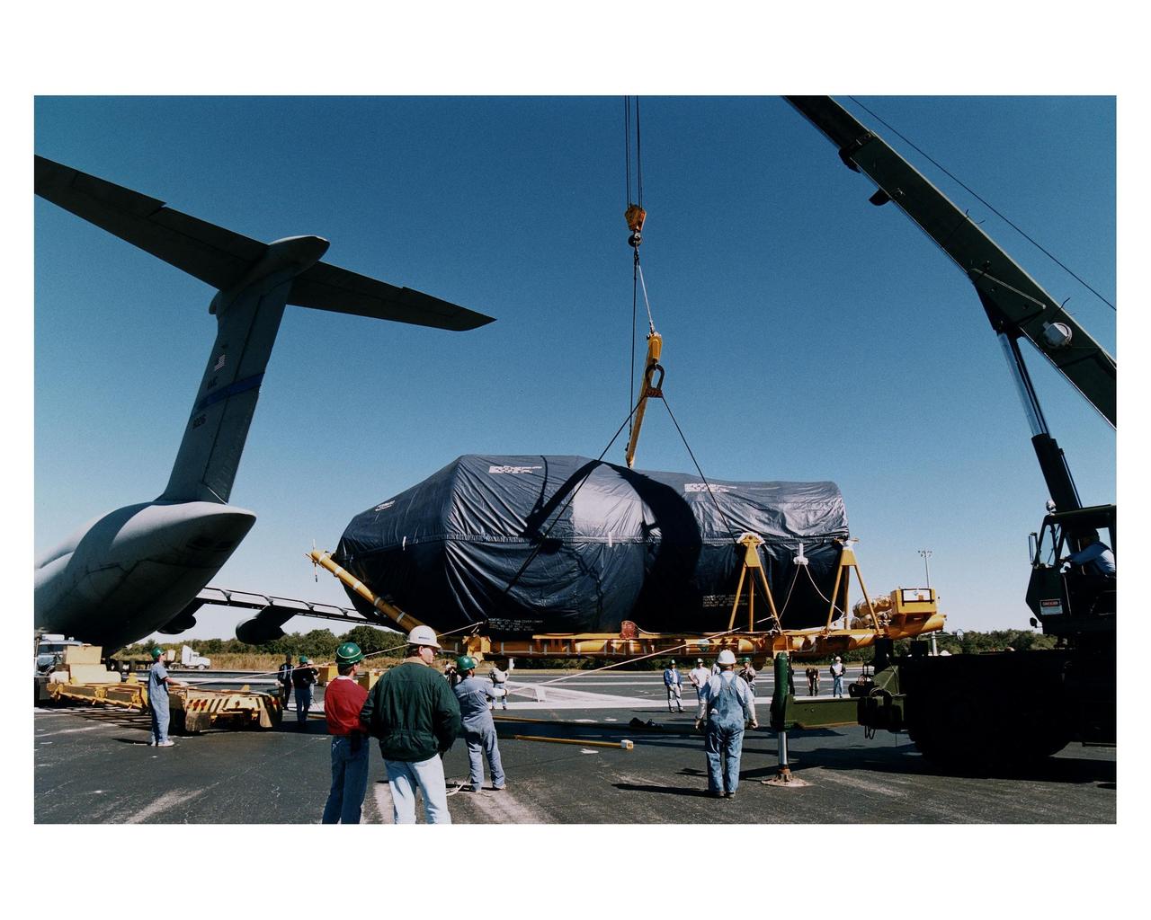 The Centaur upper stage of the Titan IV expendable launch vehicle that will propel the Cassini spacecraft to Saturn and its moon Titan is transported from the Skid Strip at Cape Canaveral Air Station (CCAS) after its arrival via a jet cargo aircraft. The Titan IV is currently scheduled to lift off from Launch Pad 40 at CCAS on October 6. Once deployed from the Centaur upper stage, Cassini will conduct gravity-assist flybys of the planets Venus and Jupiter, then arrive at Saturn in July 2004. Once there, it will perform an orbital survey of Saturn and send the European Space Agency's Huygens Probe into the dense and seemingly Earthlike atmosphere of Titan. The Cassini project is managed by NASA's Jet Propulsion Laboratory (JPL), Pasadena, California