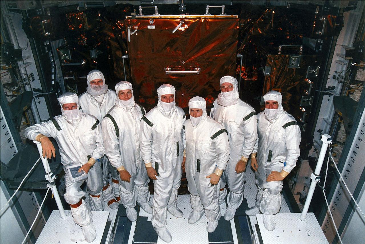 KENNEDY SPACE CENTER, FLA. -   STS-82 crew members pose in their clean room suits at Launch Pad 39A where the Space Shuttle Discovery is undergoing final preparations for liftoff on the second Hubble Space Telescope (HST) servicing mission.  They are making a final inspection of the payload before payload bay closure.  From left are Mission Specialists Steven A. Hawley and Steven L. Smith, Payload Commander Mark C. Lee, Mission Specialist GregoryJ. Harbaugh, Mission Commander Kenneth D. Bowersox, Mission Specialist Joseph R. "Joe" Tanner and Pilot Scott J. "Doc" Horowitz.  STS-82 is scheduled for liftoff on Feb. 11 during a 65-minute launch window that opens at 3:56 a.m. EST.