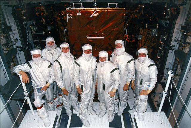 NASA image: KENNEDY SPACE CENTER, FLA. -   STS-82 crew members pose in their clean room suits at Launch Pad 39A where the Space Shuttle Discovery is undergoing final preparations for liftoff on the second Hubble Space Telescope (HST) servicing mission.  They are making a final inspection of the payload before payload bay closure.  From left are Mission Specialists Steven A. Hawley and Steven L. Smith, Payload Commander Mark C. Lee, Mission Specialist GregoryJ. Harbaugh, Mission Commander Kenneth D. Bowersox, Mission Specialist Joseph R. "Joe" Tanner and Pilot Scott J. "Doc" Horowitz.  STS-82 is scheduled for liftoff on Feb. 11 during a 65-minute launch window that opens at 3:56 a.m. EST.