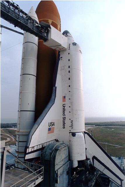 NASA image: KENNEDY SPACE CENTER, FLA. -  The White Room is seen at the upper left where the astronauts enter the Space Shuttle for flight.  The Rotating Service Structure has been retracted at KSC's Launch Pad 39A.   Discovery, the orbiter for the STS-82 mission, is ready for the launch of the second Hubble Space Telescope service mission.  The payload consists of the Near Infrared Camera and Multi-Object Spectrometer (NICMOS) that will be installed, Fine Guidance Sensor #1 (FGS-1), and the Space Telescope Imaging Spectrograph (STIS) to be installed. The STS-82 will launch with a crew of seven at 3:54 a.m. EST, Feb. 11, 1997. The launch window is 65 minutes in duration. The Mission Commander for STS-82 is Ken Bowersox. The purpose of the mission is to upgrade the scientific capabilities, service or replace aging components on the Telescope, and provide a reboost to the optimum altitude.