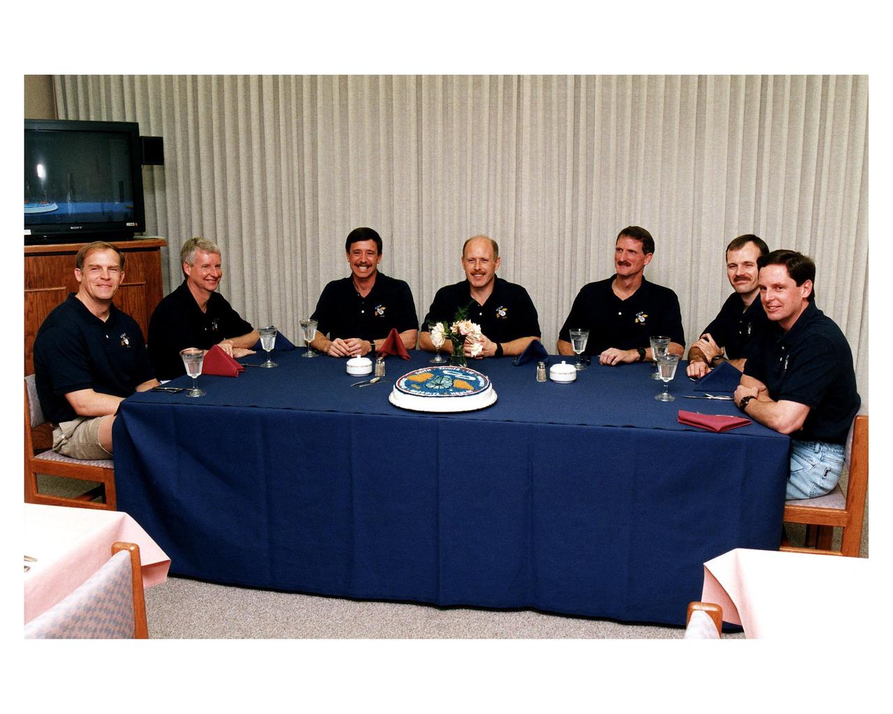 As part of the final STS-82 prelaunch activities, the seven crew members gather for lunch and a photo opportunity in the Operations and Checkout Building. From left, are Payload Commander Mark C. Lee, Mission Specialist Steven A. Hawley, Pilot Scott J. "Doc" Horowitz, Mission Commander Kenneth D. Bowersox, and Mission Specialists Joseph R. "Joe" Tanner, Steven L. Smith and Gregory J. Harbaugh. After a weather briefing, the astronauts will don their launch and entry suits and depart for Launch Pad 39A, where the Space Shuttle Discovery awaits liftoff during a 65-minute launch window which opens at about 3:55 a.m. EST, Feb. 11. The exact opening of the launch window will be announced a few hours before launch based on the final computation of the location of the Hubble Space Telescope (HST). STS-82 will be the second mission to service the HST which was deployed in 1990