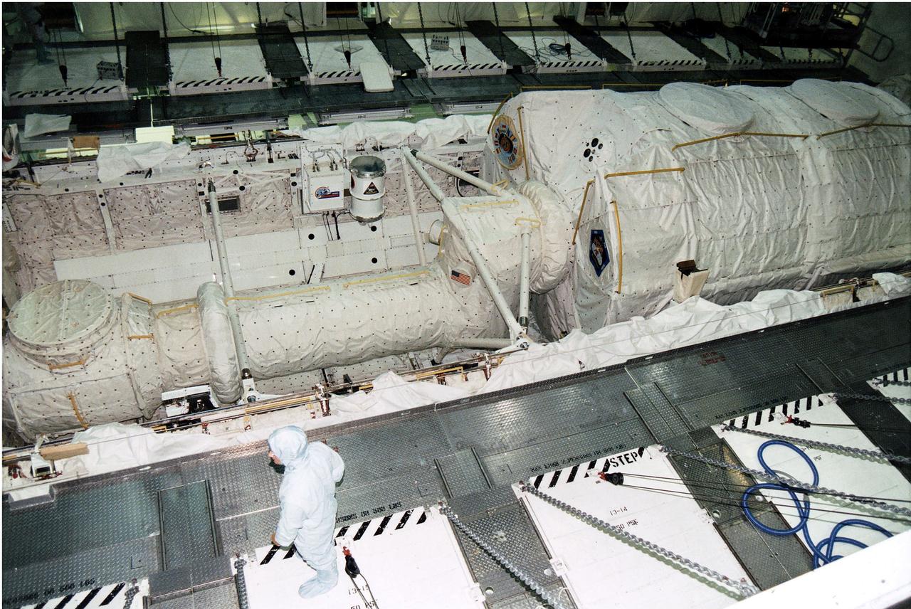 KENNEDY SPACE CENTER, FLA. - The Microgravity Science Laboratory-1 (MSL-1) Spacelab module is installed into the payload bay of the Space Shuttle Orbiter Columbia in Orbiter Processing Facility 1.  The Spacelab long crew transfer tunnel that leads from the orbiter's crew airlock to the module is also aboard, as well as the Hitchhiker Cryogenic Flexible Diode (CRYOFD) experiment payload, which is attached to the right side of Columbia's payload bay.  During the scheduled 16-day STS-83 mission, the MSL-1 will be used to test some of the hardware, facilities and procedures that are planned for use on the International Space Station while the flight crew conducts combustion, protein crystal growth and materials processing experiments.