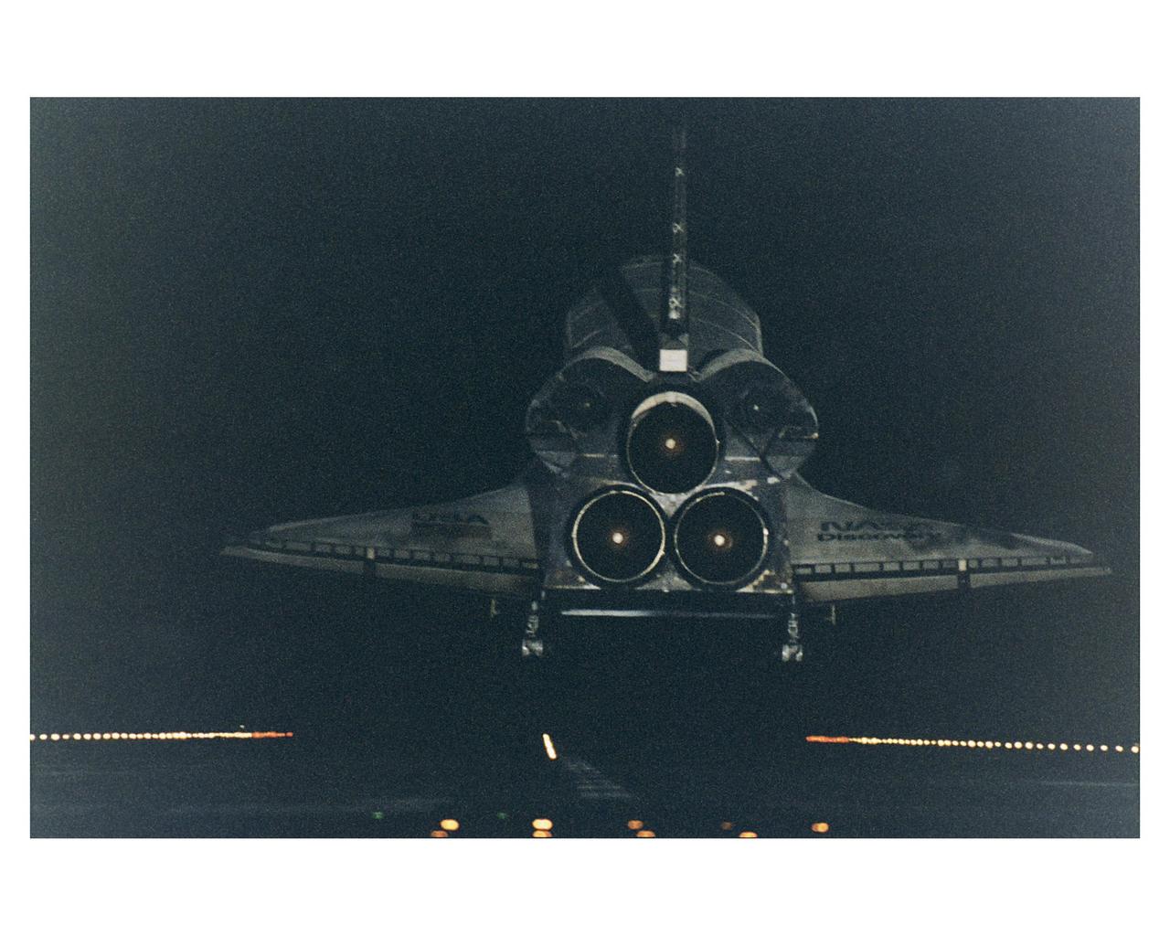 KENNEDY SPACE CENTER, Fla. -- Under the cover of darkness, the Space Shuttle orbiter Discovery glides in for a landing on Runway 15 at KSC's Shuttle Landing Facility at the conclusion of a 10-day mission to service the orbiting Hubble Space Telescope (HST). New runway centerline lights provide an additional visual aid for the nighttime landings. STS-82 is the ninth Shuttle nighttime landing, and the fourth nighttime landing at KSC. The seven-member crew performed a record-tying five back-to-back extravehicular activities (EVAs) or spacewalks to service the telescope, which has been in orbit for nearly seven years. Two new scientific instruments were installed, replacing two outdated instruments. Five spacewalks also were performed on the first servicing mission, STS-61, in December 1993. Only four spacewalks were scheduled for STS-82, but a fifth one was added during the flight to install several thermal blankets over some aging insulation covering three HST compartments containing key data processing, electronics and scientific instrument telemetry packages. Crew members are Mission Commander Kenneth D. Bowersox, Pilot Scott J. "Doc" Horowitz, Payload Commander Mark C. Lee, and Mission Specialists Steven L. Smith, Gregory J. Harbaugh, Joseph R. "Joe" Tanner and Steven A. Hawley. STS-82 was the 82nd Space Shuttle flight and the second mission of 1997