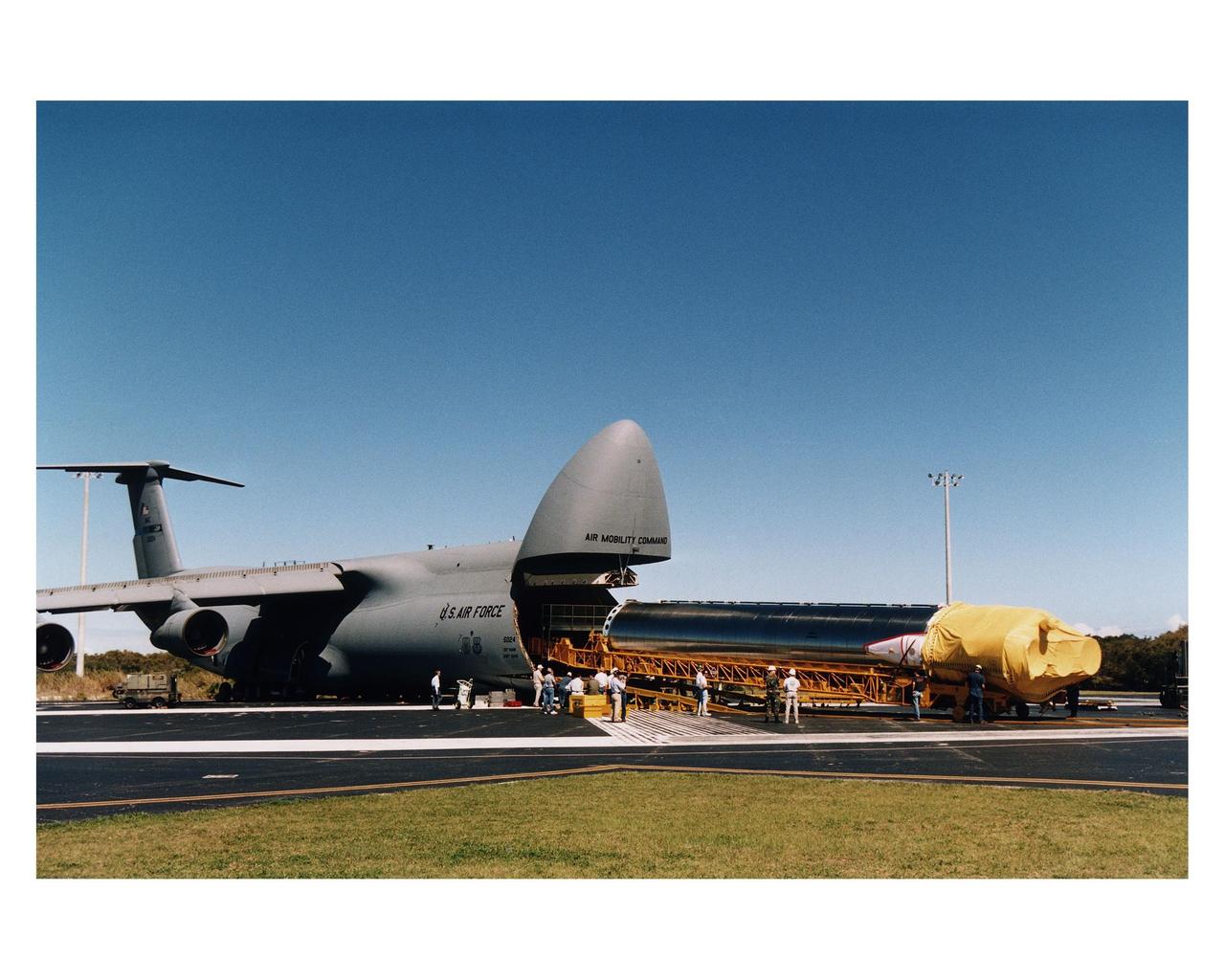 The Atlas 1 rocket which will launch the GOES-K advanced weather satellite is unloaded from an Air Force C-5 air cargo plane after arrival at the Skid Strip, Cape Canaveral Air Station (CCAS). The Lockheed Martin-built rocket and its Centaur upper stage will form the AC-79 vehicle, the final vehicle in the Atlas 1 series which began launches for NASA in 1962. Future launches of geostationary operational environmental satellites (GOES) in the current series will be on Atlas II vehicles. GOES-K will be the third spacecraft to be launched in the new advanced series of geostationary weather satellites built for NASA and the National Oceanic and Atmospheric Administration (NOAA). The spacecraft will be designated GOES-10 in orbit. The launch of AC-79/GOES-K is targeted for April 24 from Launch Pad 36B, CCAS