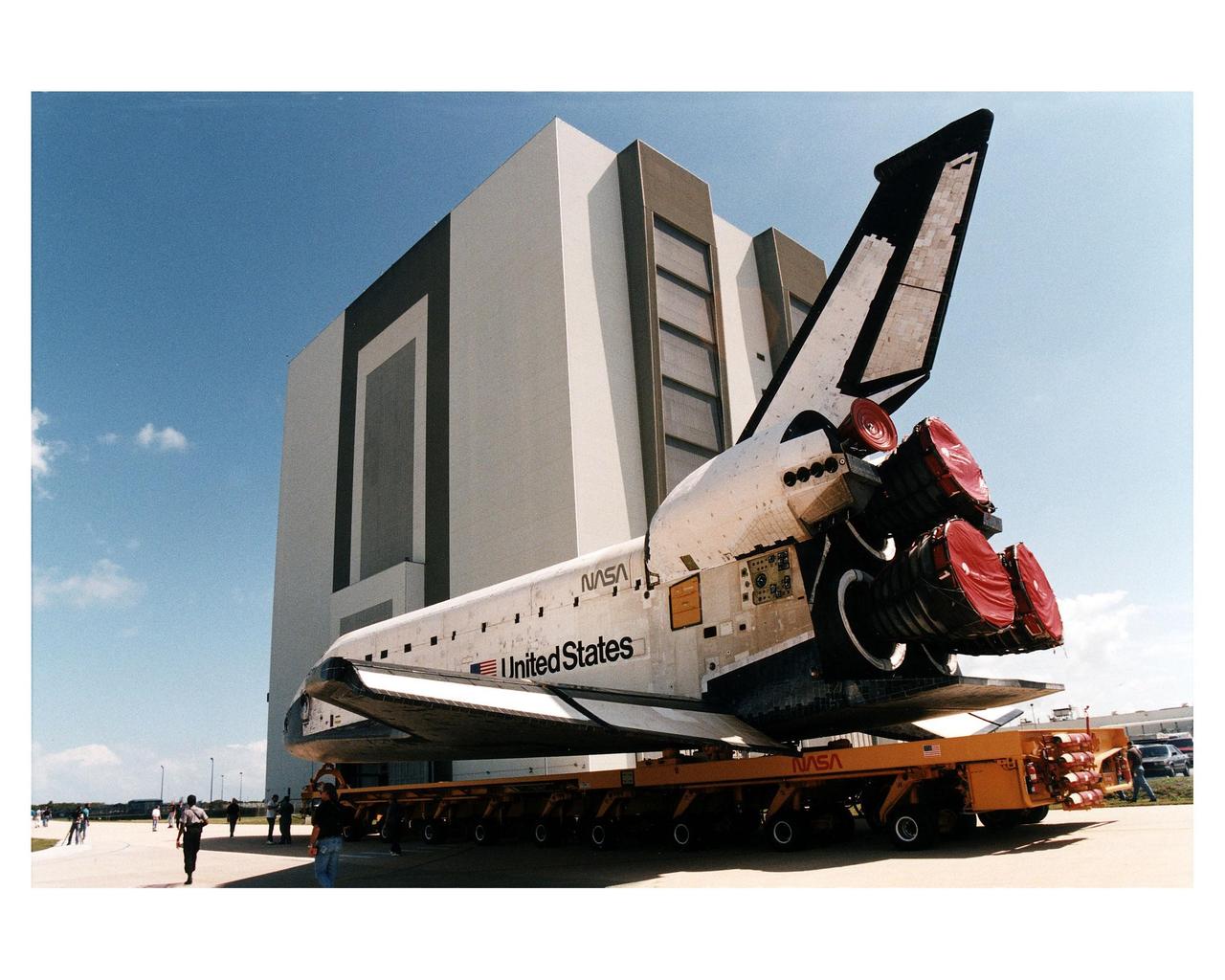 Space Shuttle Columbia rolls over from Orbiter Processing Facility bay 1 to the Vehicle Assembly Building to be mated to its external tank/solid rocket booster stack. Roll out to Pad 39A in preparation for mission STS-83 is set for first motion at 7 a.m. on Tuesday. Launch is currently targeted for April 3 at 2:01 p.m. EST