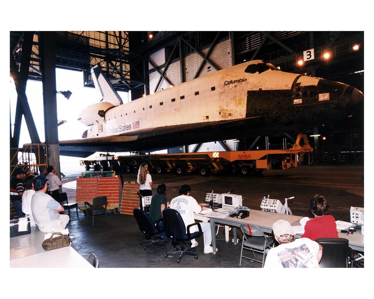 Space Shuttle Columbia rolls over from Orbiter Processing Facility bay 1 to the Vehicle Assembly Building to be mated to its external tank/solid rocket booster stack. Roll out to Pad 39A in preparation for mission STS-83 is set for first motion at 7 a.m. on Tuesday. Launch is currently targeted for April 3 at 2:01 p.m. EST