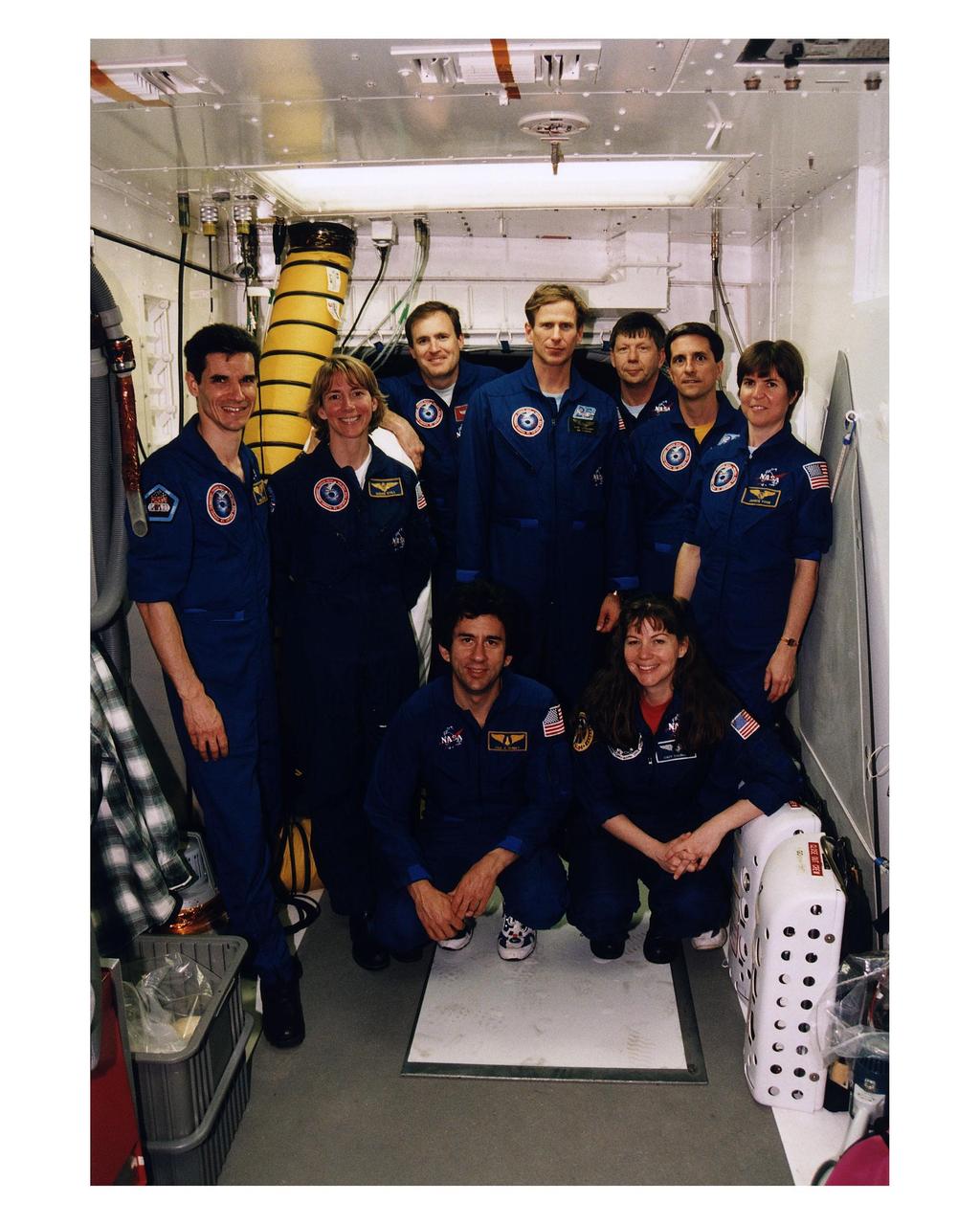 The STS-83 crew poses in the White Room at Launch Complex 39A during the crew's <a href="http://www-pao.ksc.nasa.gov/kscpao/release/1997/40-97.htm">Terminal Countdown Demonstration Test (TCDT).</a> From left to right, standing, they are Payload Specialist Gregory T. Linteris, Pilot Susan L. Still, Mission Commander James D. Halsell, Mission Specialist Michael L. Gernhardt, Payload Specialist Roger K. Crouch, and Mission Specialists Donald Thomas and Janice E. Voss. Cady Coleman, the backup Mission Specialist for Donald Thomas, is kneeling on the right