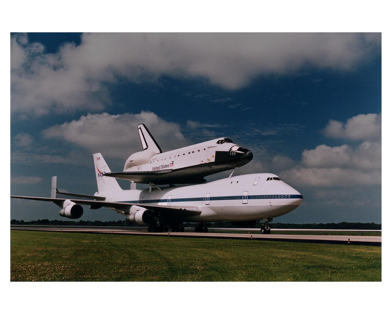 The orbiter Endeavour, riding atop the 747 Shuttle Carrier Aircraft (SCA), landed at KSC's Shuttle Landing Facility at about 9:44 a.m. today, completing is cross-country ferry flight from Palmdale, CA. Endeavour departed Palmdale at about 9 a.m. EST March 26 and stopped briefly for fuel at Ft. Worth Naval Air Station, TX. The vehicle then proceeded to Warner Robbins Air Force Base, GA, where it stayed overnight last night before departing for KSC this morning. Endeavour will be removed from the SCA today and transported to Orbiter Processing Facility bay 1 early tomorrow morning
