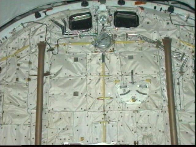 Yesterday, NASA decided to postpone for 24-hours the launch of Columbia on mission STS-83 due to a requirement to add additional thermal insulation to water coolant lines in the orbiter's payload bay. The water coolant lines are seen here winding their way around the window on the left. Managers determined that the lines, which cool various electronics on the orbiter, were not properly insulated and could possibly freeze during Columbia's 16-days in space. Columbia's launch is now set for 2:00 p.m. EST on Friday, April 4, 1997