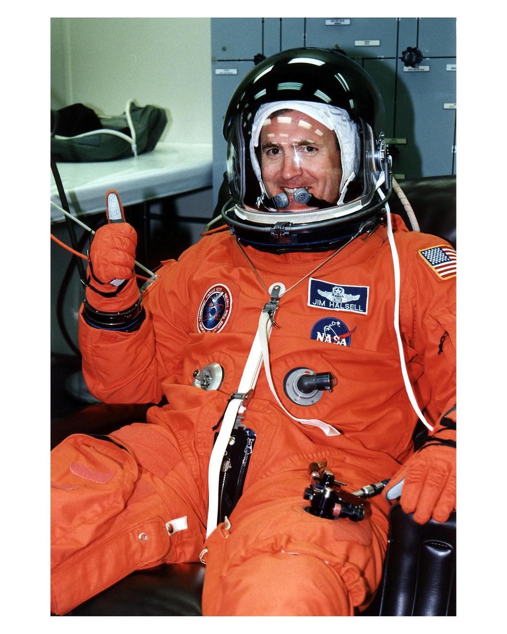 STS-83 Mission Commander James D. Halsell, Jr., gives a thumbs-up after he is assisted into his launch/entry suit in the Operations and Checkout (O&C) Building. Halsell is on his third space flight, having served as pilot of both STS-74 and STS-65. He is a lieutenant colonel in the Air Force and a former SR-71 Blackbird test pilot and holds master's degrees in management and space operations. Halsell will have responsibility for the success of the mission and will operate and maintain Columbia during the Red, or second shift. He will also assist with a materials science experiment and a protein crystal growth payload during the 16-day mission. Halsell and six fellow crew members will shortly depart the O&C and head for Launch Pad 39A, where the Space Shuttle Columbia will lift off during a launch window that opens at 2:00 p.m. EST, April 4