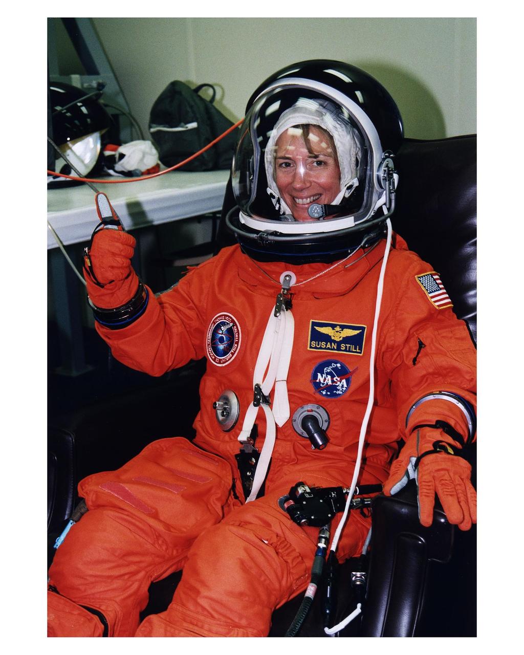 STS-83 Pilot Susan L. Still gives a thumbs-up as she is assisted into her launch/entry suit in the Operations and checkout (O&C) Building. She is the second woman to fly in this capacity on a Space Shuttle. Still is a lieutenant colonel in the Navy and has more than 2,000 flight hours in 30 different types of aircraft. She also holds a master's degree in aerospace engineering. Still will assist Halsell with all phases of the space flight and will have primary responsibility to take action in the event of an emergency. After Columbia reaches orbit, Still will be busy with the many and varied tasks associated with monitoring and maintaining the orbiter. She and six fellow crew members will shortly depart the O&C and head for Launch Pad 39A, where the Space Shuttle Columbia will lift off during a launch window that opens at 2:00 p.m. EST, April 4