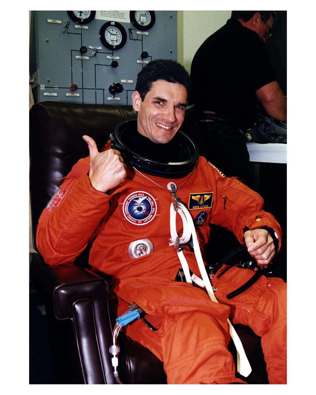 STS-83 Payload Specialist Gregory T. Linteris gives a thumbs-up as he is assisted into his launch/entry suit in the Operations and Checkout (O&C) Building. He holds a doctorate in mechanical and aerospace engineering. Linteris has worked at the National Institute of Standards and Technology and is the Principal Investigator on a NASA microgravity combustion experiments. As a member of the Red team, Linteris will concentrate on three combustion experiments. Two of these experiments are housed in the Combustion Module. He will also be backing up crew members on the other Microgravity Science Laboratory-1 (MSL-1) investigations. He and six fellow crew members will shortly depart the O&C and head for Launch Pad 39A, where the Space Shuttle Columbia will lift off during a launch window that opens at 2:00 p.m. EST, April 4