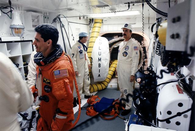 NASA image: KENNEDY SPACE CENTER, FLA. - STS-83 Payload Specialist Gregory T. Linteris chats with White Room closeout crew members as he prepares to enter the Space Shuttle Columbia at Launch Pad 39A. Closeout crew workers Max Kandler (second from right) and Bob Saulnier wait to assist Linteris with his ascent/reentry suit.